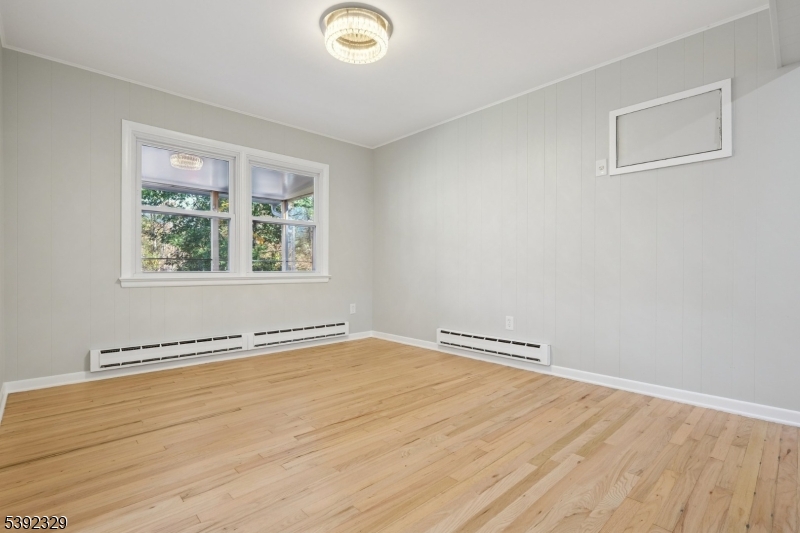 5 Weatherhill Road Lebanon, NJ 08833 - Photo 19 of 47 an empty room with wooden floor and windows