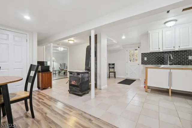 a large white kitchen with white cabinets and stainless steel appliances
