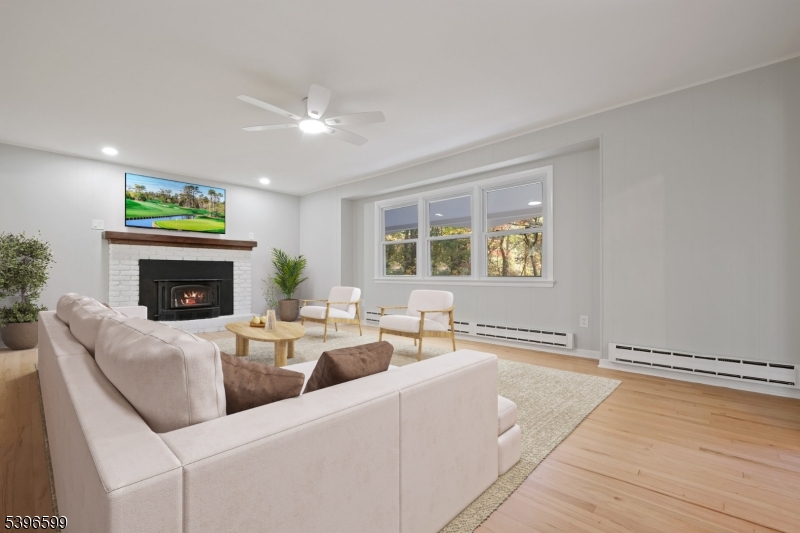 5 Weatherhill Road Lebanon, NJ 08833 - Photo 9 of 47 a living room with furniture a fireplace and a flat screen tv