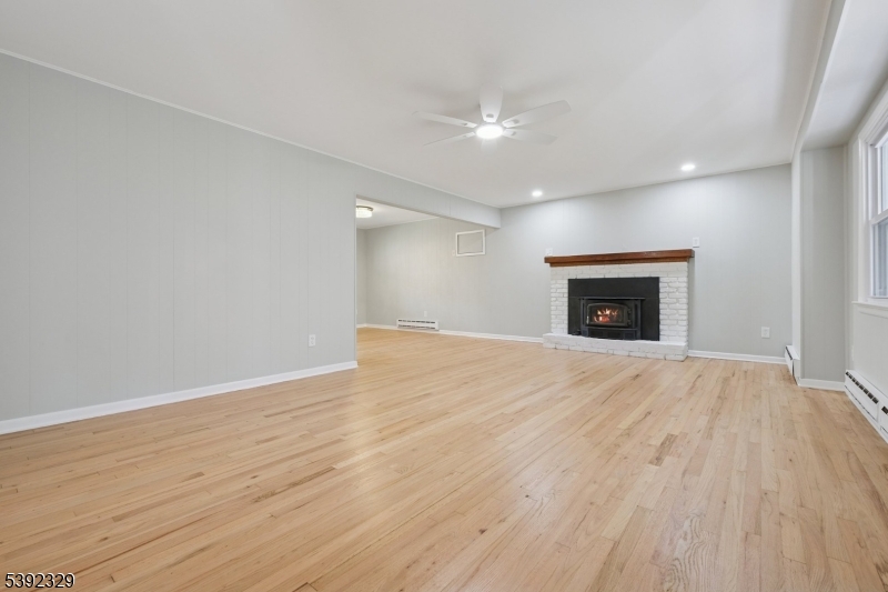 5 Weatherhill Road Lebanon, NJ 08833 - Photo 10 of 47 an empty room with wooden floor a fireplace and a window