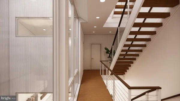 a view of a hallway with wooden floor and staircase