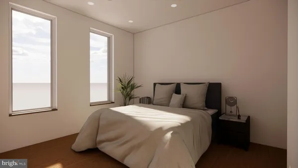 a large bed sitting in a bedroom next to a window