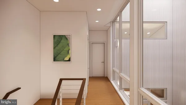 a view of a hallway with wooden floor and a bathroom