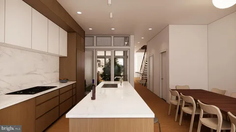 a large kitchen with a table and chairs