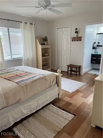 a bedroom with a bed a dresser and a window