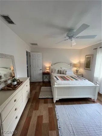 a spacious bedroom with a bed and a dresser in it