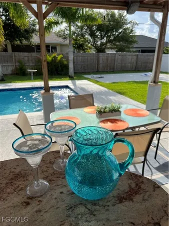 a swimming pool with outdoor seating and yard