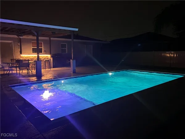 a room with pool table and chairs