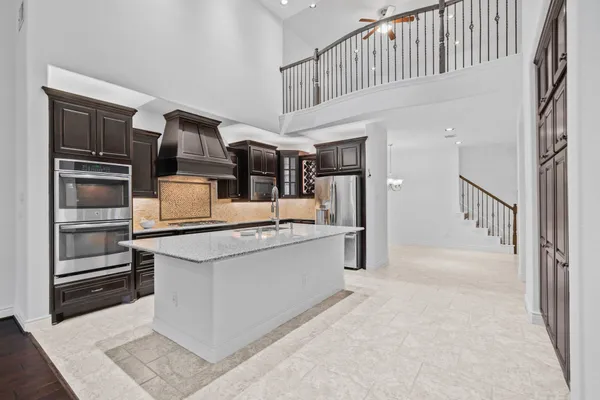 a kitchen with a sink and chandelier