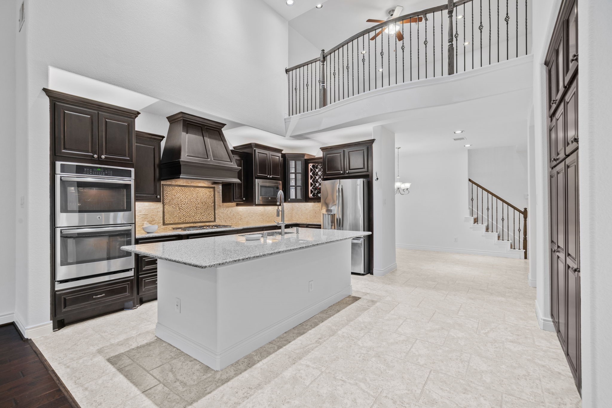 24211 Cordova Brook Lane Katy, TX 77494 - Photo 15 of 42 a kitchen with stainless steel appliances kitchen island granite countertop a refrigerator and a stove