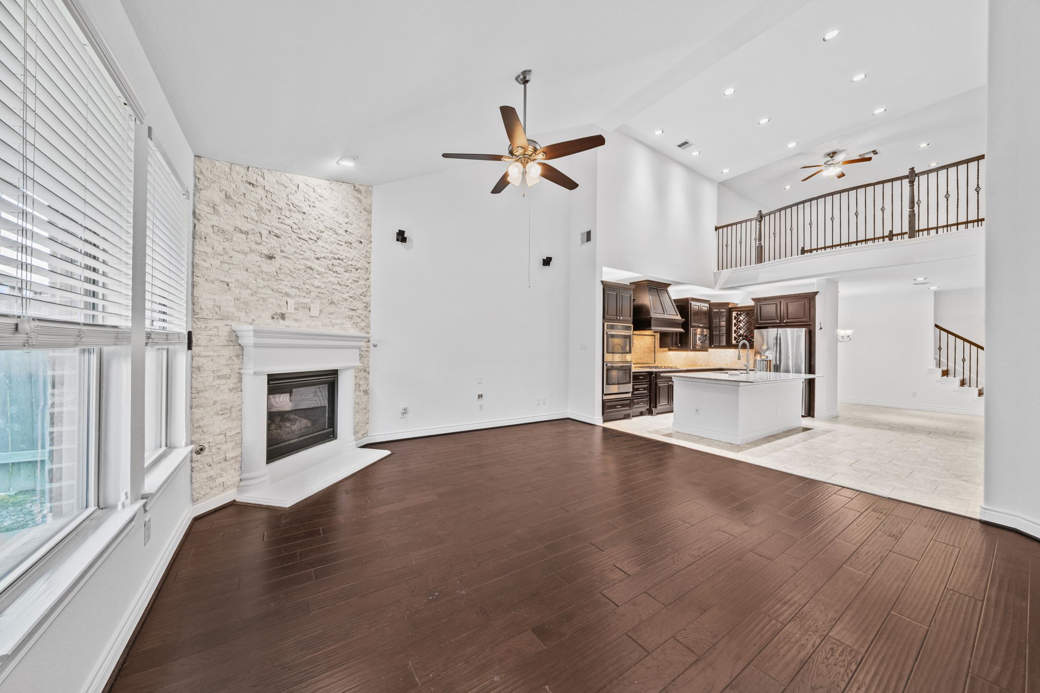 24211 Cordova Brook Lane Katy, TX 77494 - Photo 18 of 42 an empty room with wooden floor a ceiling fan and windows