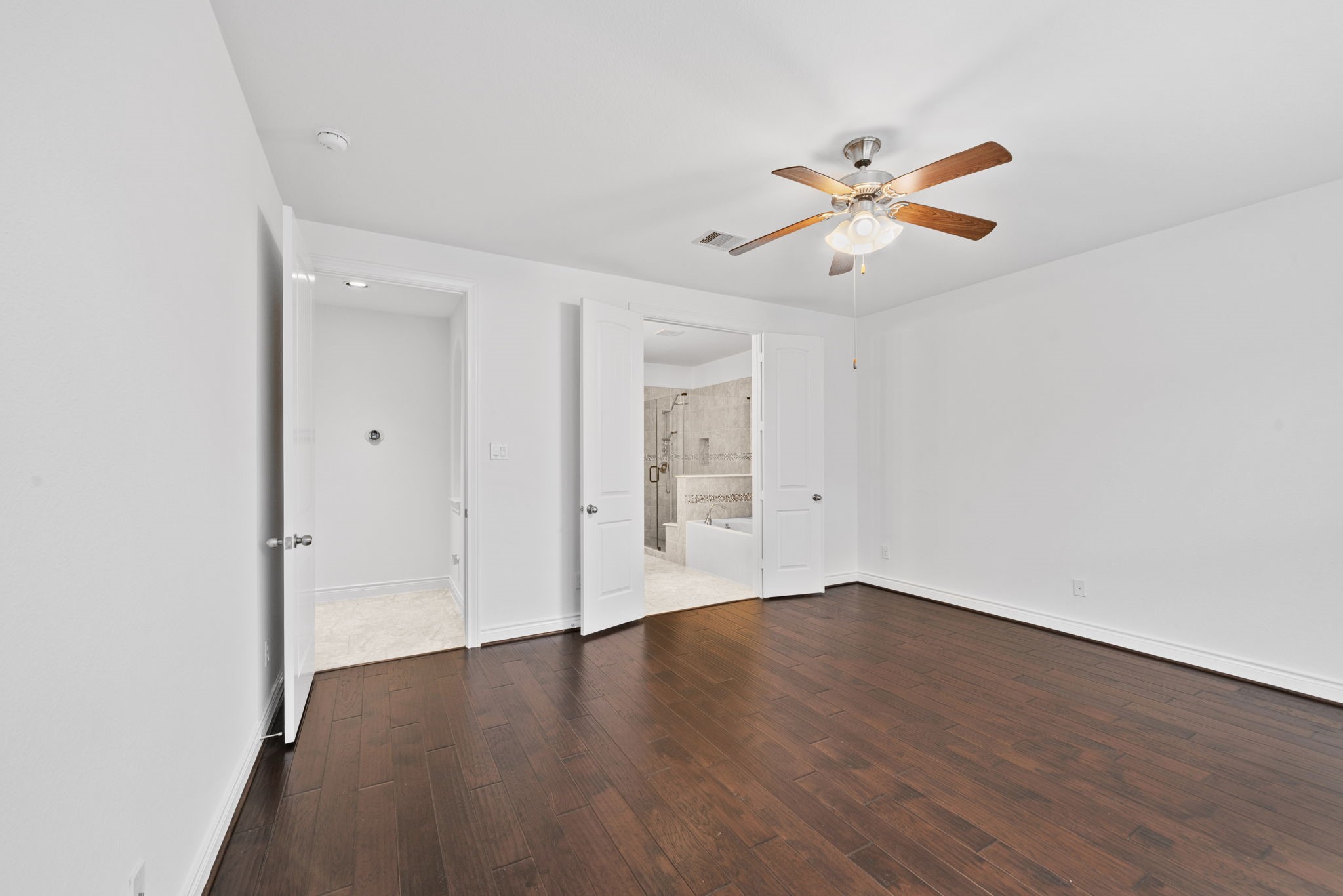 24211 Cordova Brook Lane Katy, TX 77494 - Photo 22 of 42 an empty room with wooden floor ceiling fan and window