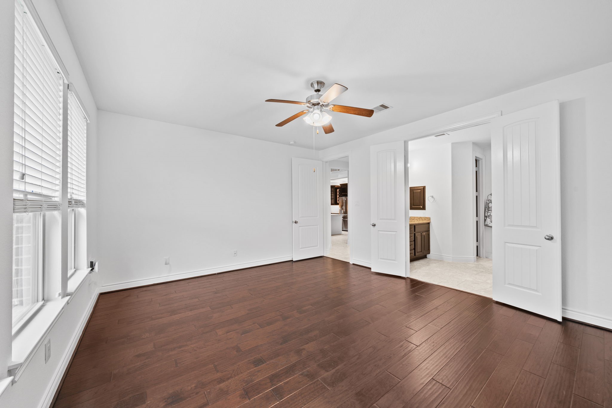 24211 Cordova Brook Lane Katy, TX 77494 - Photo 23 of 42 an empty room with wooden floor and windows