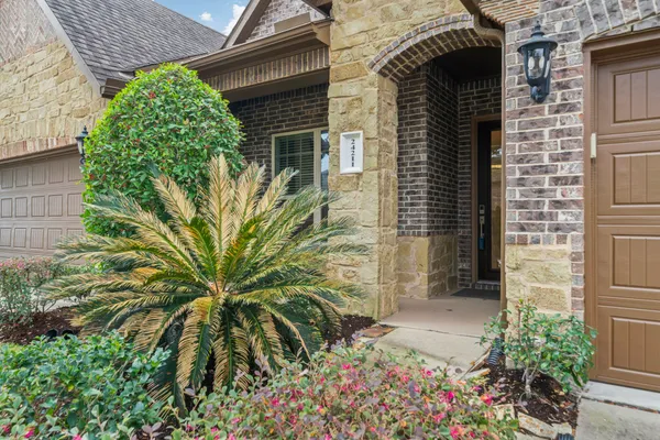 a potted plant in front of a brick house