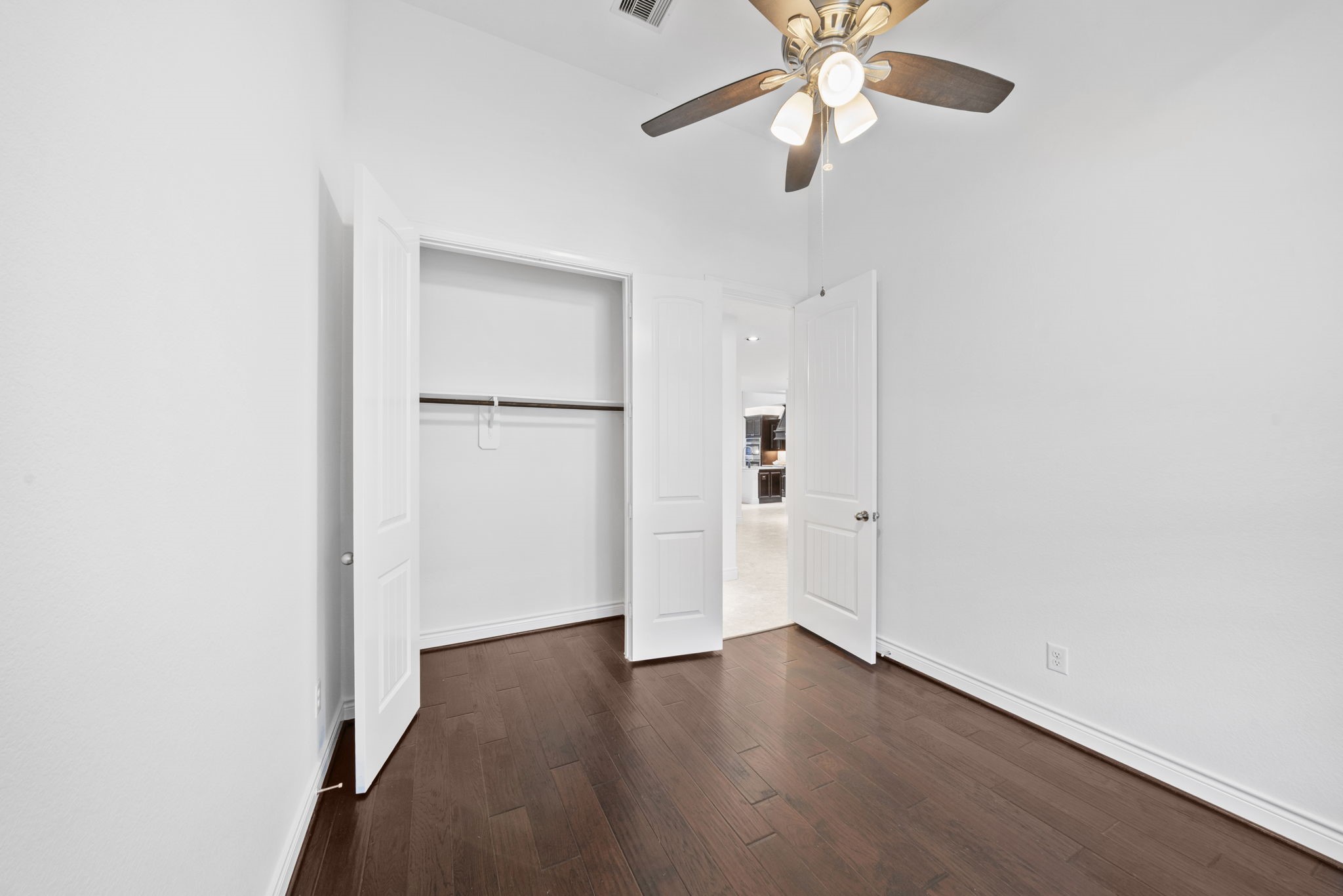 24211 Cordova Brook Lane Katy, TX 77494 - Photo 7 of 42 a view of a room with wooden floor closet and a ceiling fan