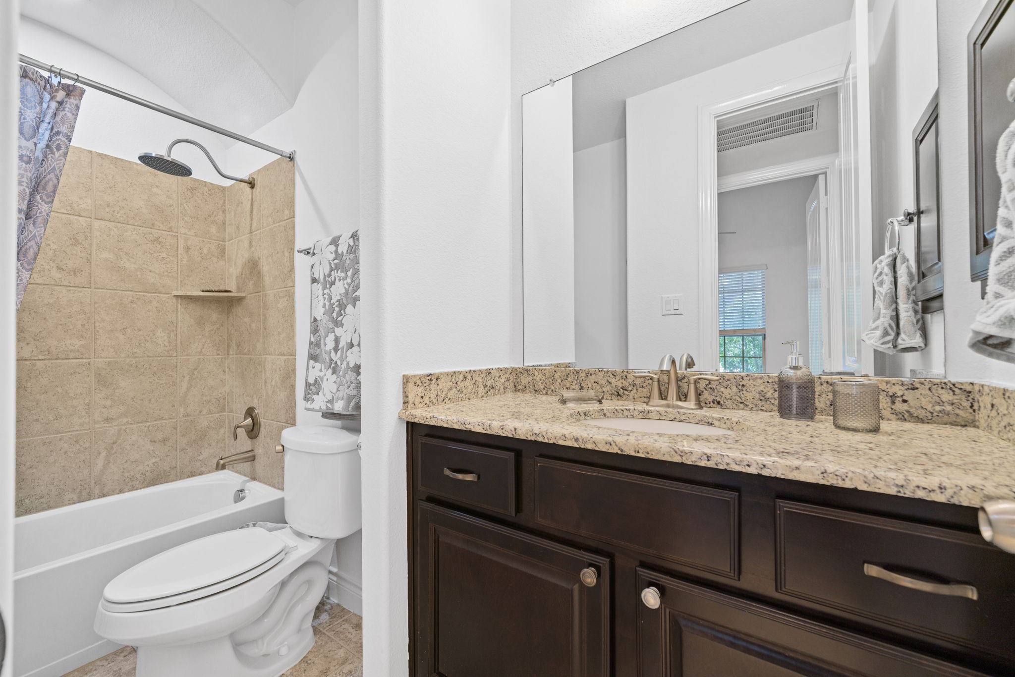 24211 Cordova Brook Lane Katy, TX 77494 - Photo 8 of 42 a bathroom with a granite countertop toilet sink and mirror