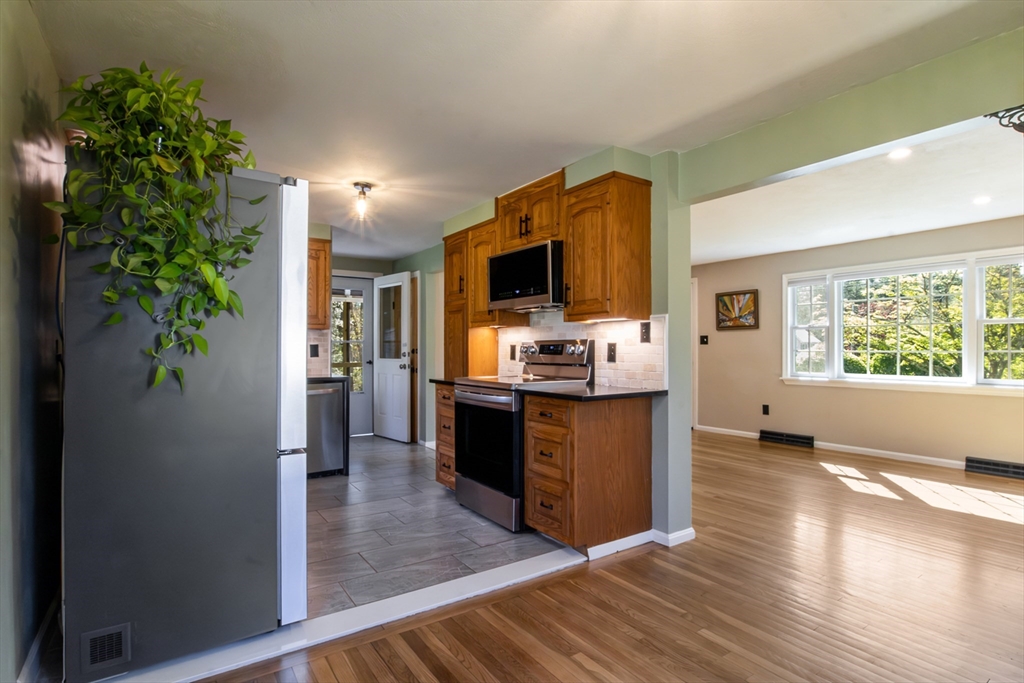 196 Center Street Groveland, MA 01834 - Photo 8 of 32 a kitchen with kitchen island a counter top space a sink and appliances