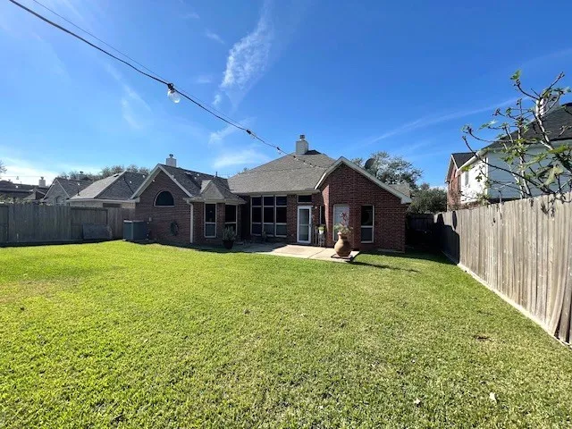 a view of a house with a yard and sitting area