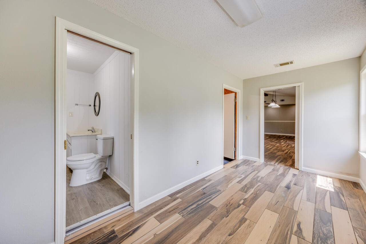 5811 Monroe Street Baker, FL 32531 - Photo 16 of 33 a bathroom with a toilet and a shower