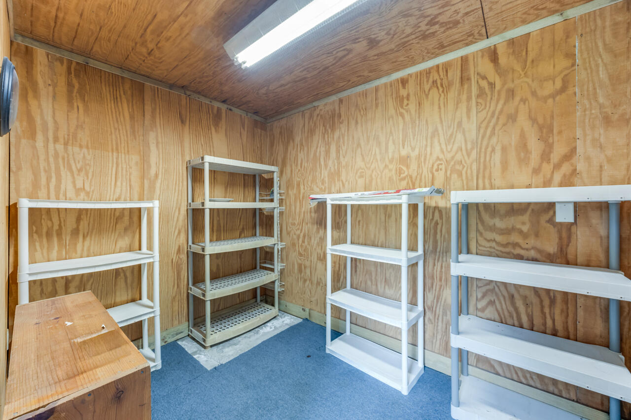 5811 Monroe Street Baker, FL 32531 - Photo 19 of 33 a view of a bedroom with wooden floor and windows
