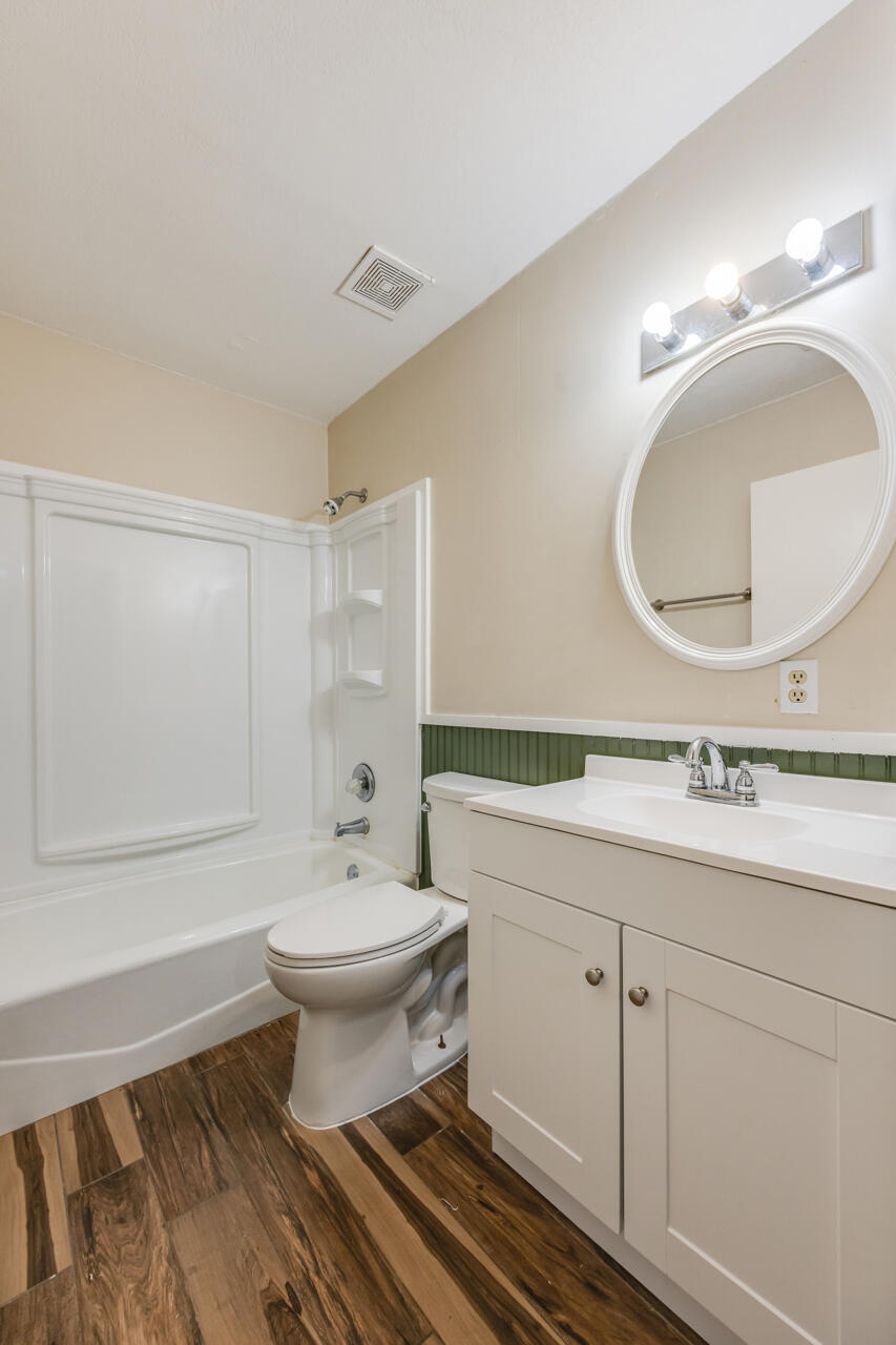 5811 Monroe Street Baker, FL 32531 - Photo 30 of 33 a bathroom with a double vanity sink mirror and toilet