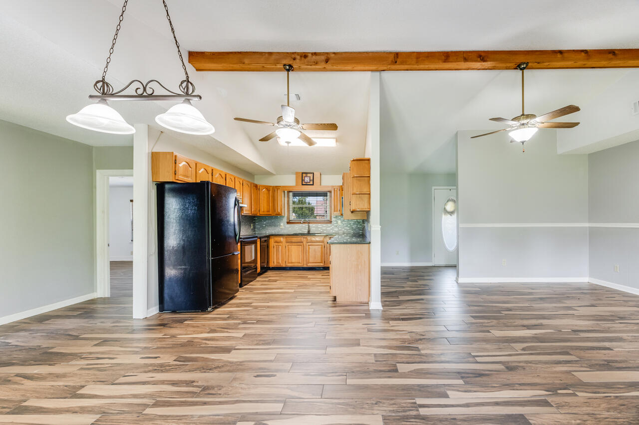 5811 Monroe Street Baker, FL 32531 - Photo 8 of 33 a view of a kitchen with a refrigerator and a table