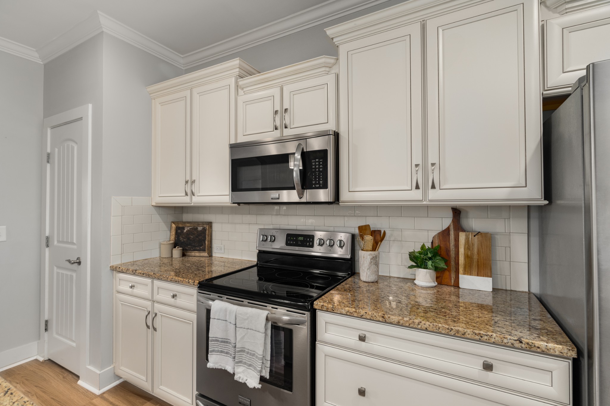 4021 Viola Lane Franklin, TN 37069 - Photo 13 of 34 a kitchen with stainless steel appliances granite countertop white cabinets sink and dishwasher