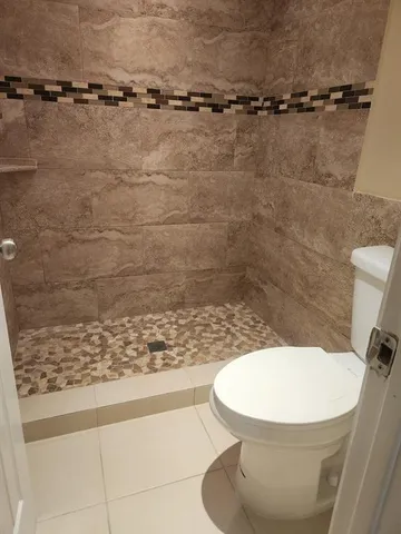 a bathroom with a granite countertop sink and a wooden cabinets