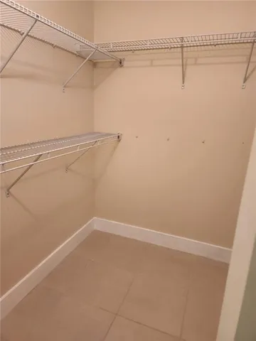 en empty room with stairs and glass door