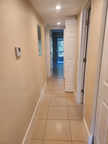 a view of hallway with stairs and a window