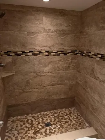 a bathroom with a toilet and a shower