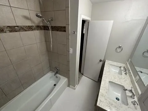 a bathroom with a tub a sink and a shower