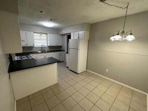 4408 Chicago Avenue Lubbock, TX 79414 - Photo 5 of 19 a kitchen with stainless steel appliances a refrigerator sink and cabinets