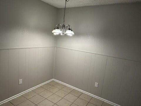 4408 Chicago Avenue Lubbock, TX 79414 - Photo 6 of 19 an empty room with chandelier fan and kitchen view