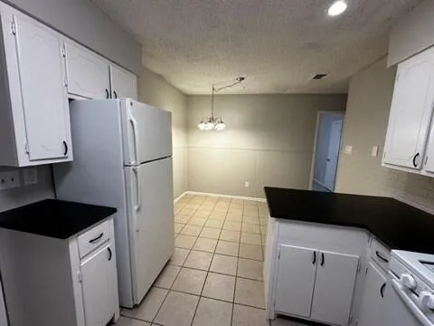 a kitchen with a refrigerator and a stove