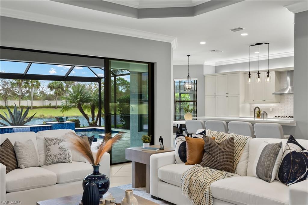 4398 Caldera Circle Naples, FL 34119 - Photo 19 of 50 a living room with furniture and a large window