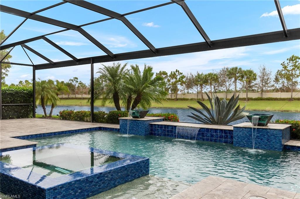 4398 Caldera Circle Naples, FL 34119 - Photo 2 of 50 a view of swimming pool with a patio and a yard