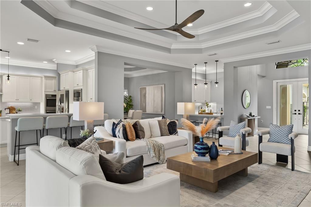 4398 Caldera Circle Naples, FL 34119 - Photo 21 of 50 a living room with furniture and a chandelier