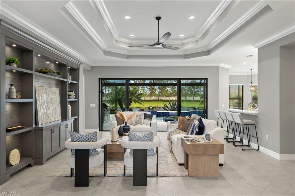 4398 Caldera Circle Naples, FL 34119 - Photo 22 of 50 a living room with furniture a lamp and a large window