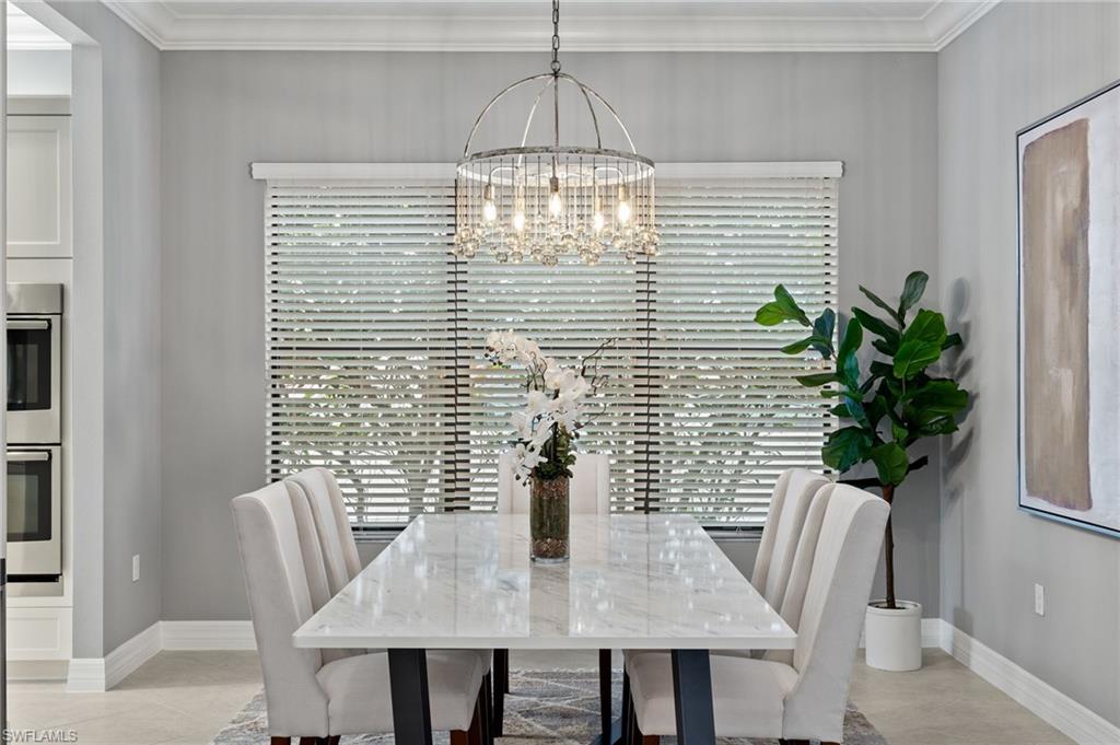 4398 Caldera Circle Naples, FL 34119 - Photo 24 of 50 a view of a dining room with furniture and a potted plant
