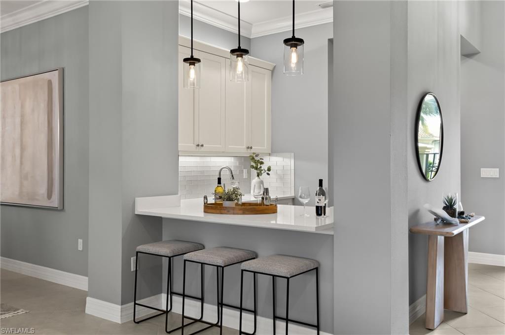 4398 Caldera Circle Naples, FL 34119 - Photo 26 of 50 a view of a dining room with furniture and a mirror