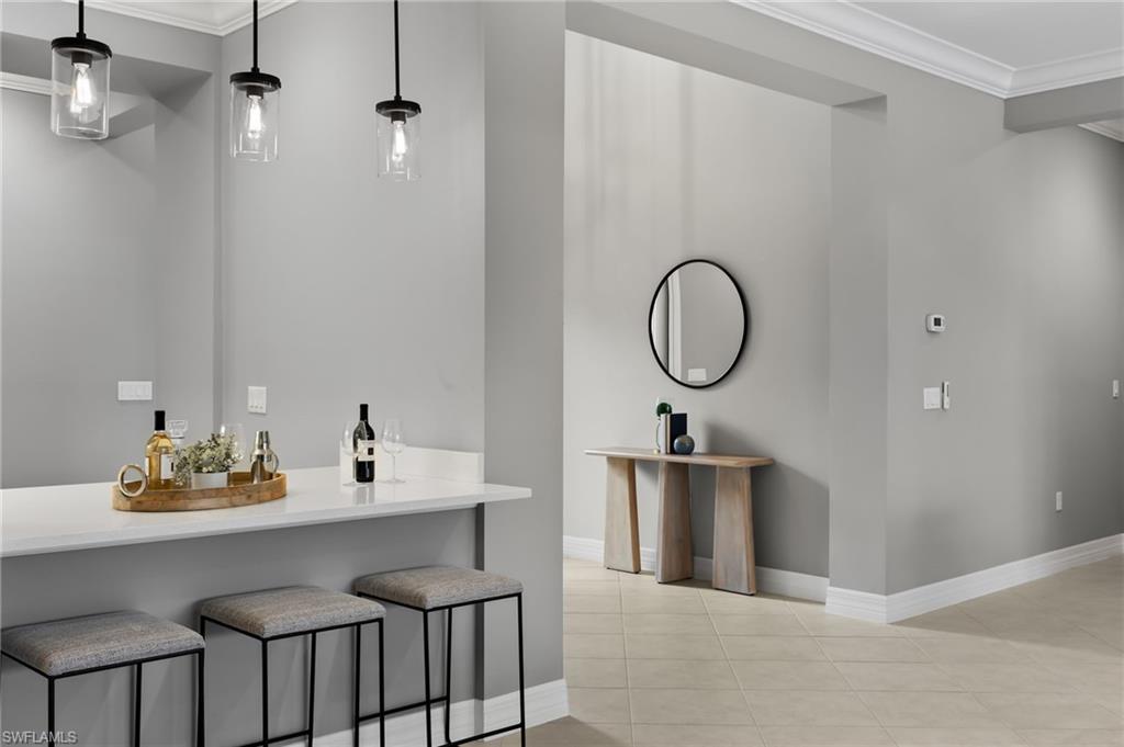 4398 Caldera Circle Naples, FL 34119 - Photo 27 of 50 a view of a dining room with a table and chairs