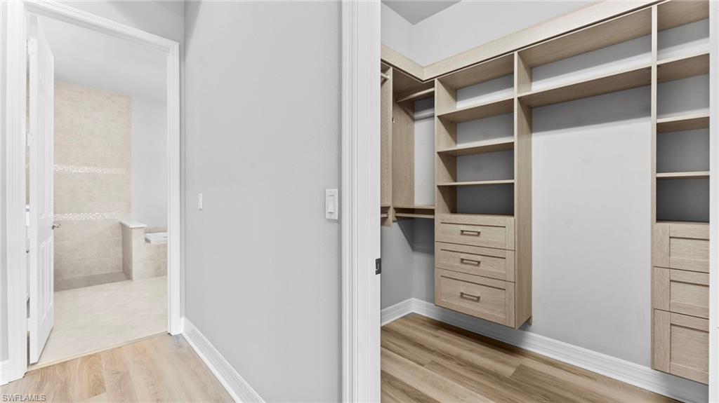 4398 Caldera Circle Naples, FL 34119 - Photo 35 of 50 a view of walk in closet and bedroom
