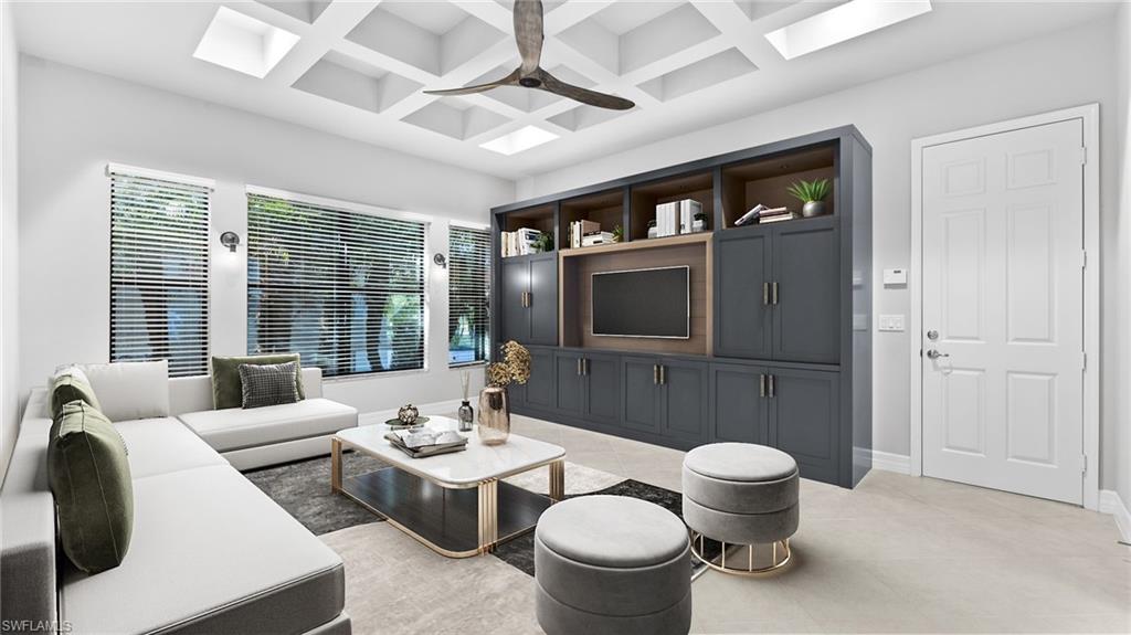 4398 Caldera Circle Naples, FL 34119 - Photo 40 of 50 a living room with furniture a flat screen tv and a large window