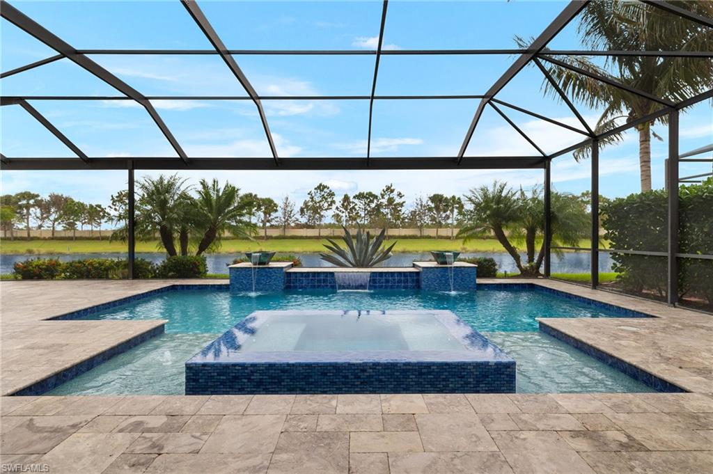 4398 Caldera Circle Naples, FL 34119 - Photo 9 of 50 a living room with a floor to ceiling window pool table and chairs