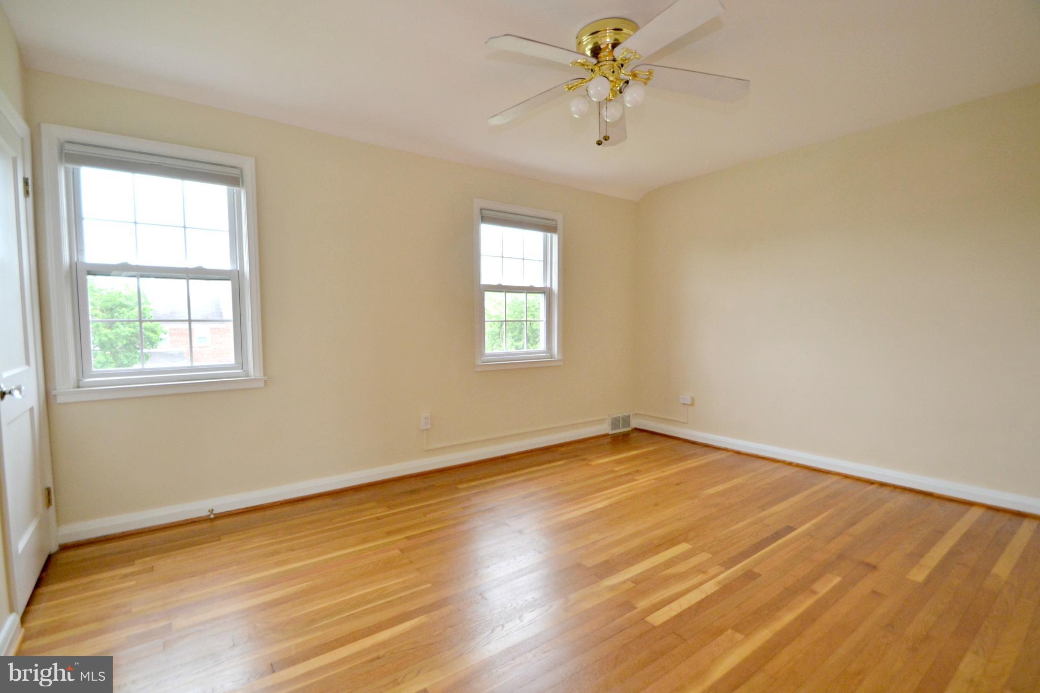1306 Cedarcroft Road Baltimore, MD 21239 - Photo 14 of 21 a view of an empty room with a window and wooden floor