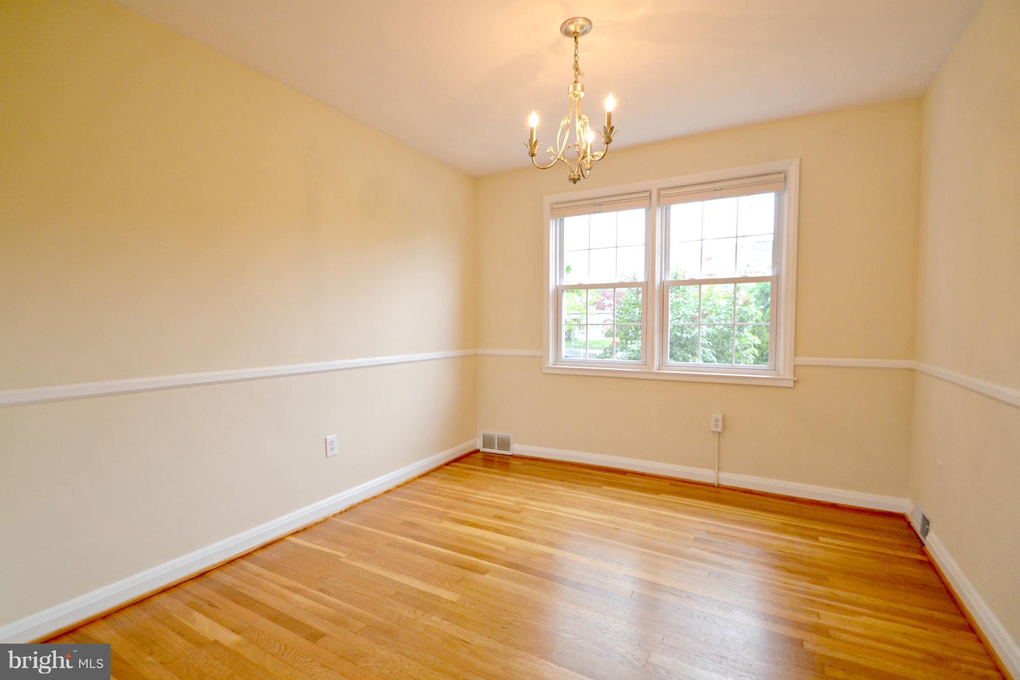 1306 Cedarcroft Road Baltimore, MD 21239 - Photo 8 of 21 a view of empty room with wooden floor and fan