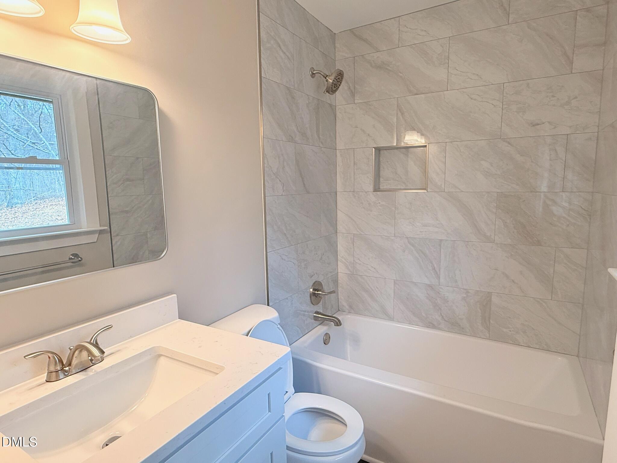 1209 Snow Hill Road Durham, NC 27712 - Photo 11 of 14 a bathroom with a granite countertop sink toilet and bathtub
