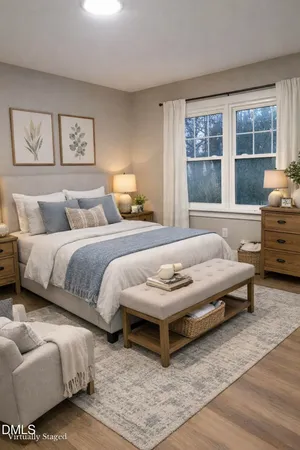 a bedroom with furniture and a large window
