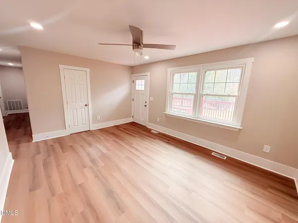 wooden floor in an empty room with a window